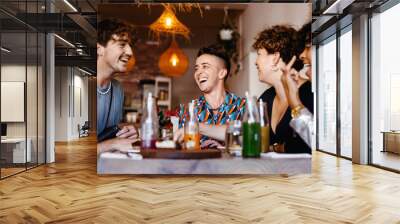 Laughing friends in a restaurant Wall mural