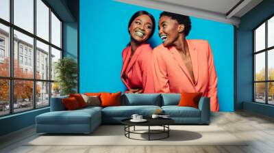 Laughing young women in stylish clothing Wall mural