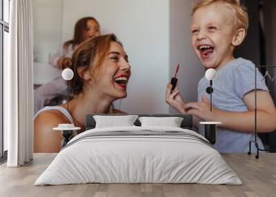 Little boy playing with his mothers makeup Wall mural