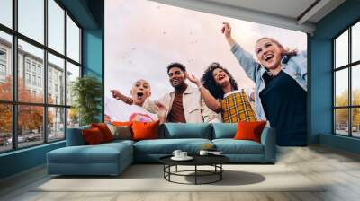 Low angle view of friends partying on a rooftop Wall mural