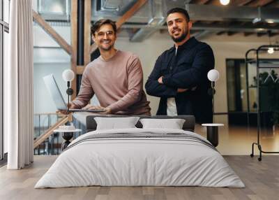 Male business professionals standing together on an interior balcony Wall mural