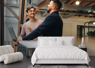 Male tech professionals having a discussion in an office Wall mural