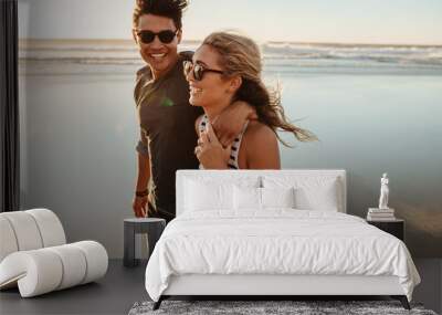 Man and woman on beach holiday Wall mural