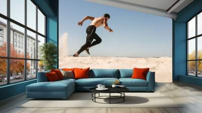 Man running on the beach Wall mural