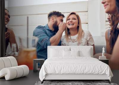 Man sharing a secret with woman in a party Wall mural