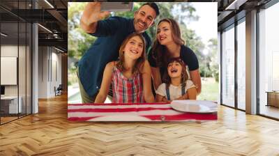 Man taking a selfie of his family Wall mural