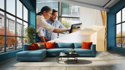 Manager working with colleague on a project Wall mural