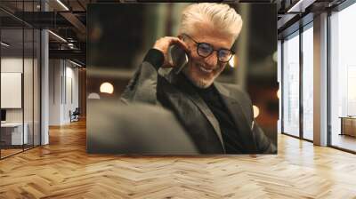 Mature business executive making a phone call Wall mural