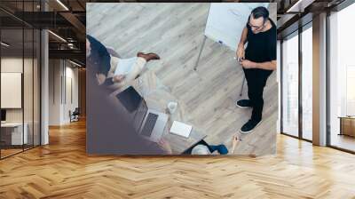 Mature businessman presenting his ideas to team Wall mural