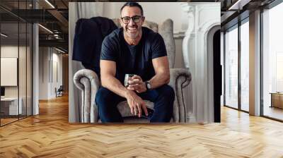 Mature businessman relaxing in hotel room Wall mural