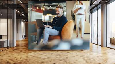 Mature businessman working in a co-working space Wall mural