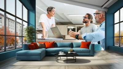 Mature businesswoman having a discussion with her colleagues in an office Wall mural