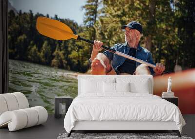 mature man paddling a kayak Wall mural