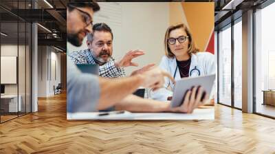 Medical staff during morning briefing in boardroom Wall mural