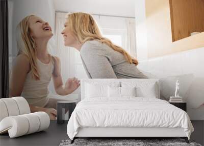 Mother and daughter enjoying in bedroom Wall mural