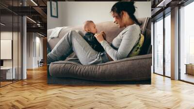 Mother spending time talking to her baby at home Wall mural