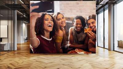 Mulltiracial friends taking selfie at pizza restaurant Wall mural