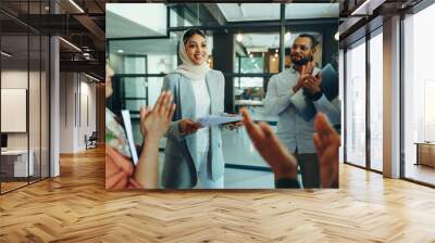 Multicultural businesspeople applauding their colleague Wall mural