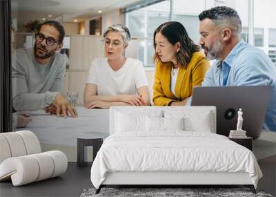 Multicultural designer sharing ideas during a meeting Wall mural