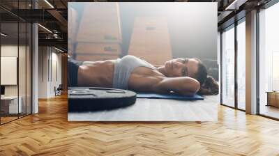 muscular female relaxing after exercise session Wall mural