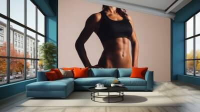 Muscular young woman in sportswear Wall mural