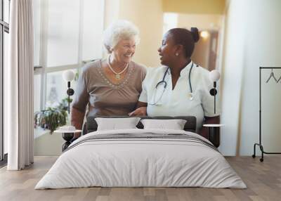 Nurse assisting senior woman at nursing home Wall mural