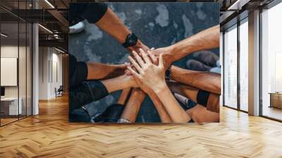 Office workers making a stack of hands Wall mural