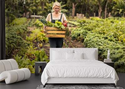 Organic farmer harvesting fresh vegetables on her farm Wall mural