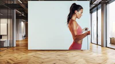 Portrait of a fitness woman with skipping rope Wall mural