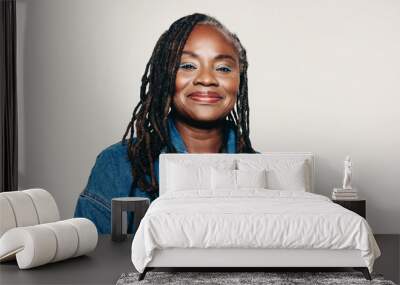 Portrait of a mature woman with dreadlocks looking at the camera with a smile Wall mural