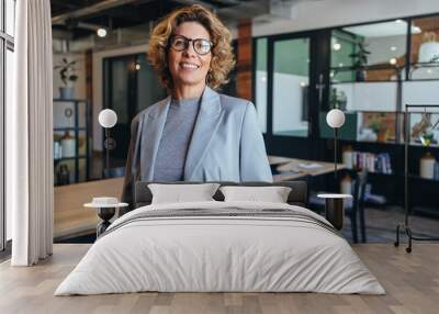 Portrait of a professional woman in a suit. Business woman standing in an office Wall mural