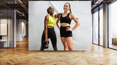 Portrait of a woman with her fitness trainer Wall mural