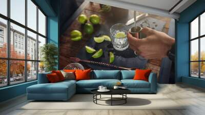 Pouring alcohol in jigger to prepare a cocktail Wall mural