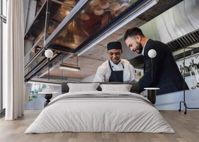 Restaurant manager with chef in kitchen Wall mural