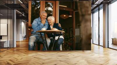 Retirement couple relaxing at cafe Wall mural