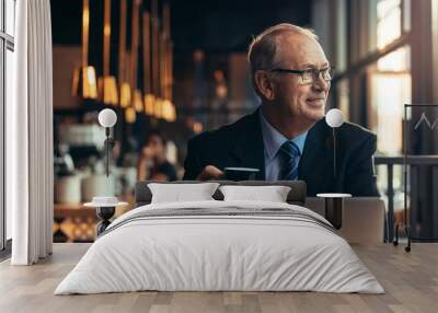 Senior businessman relaxing at coffee shop Wall mural