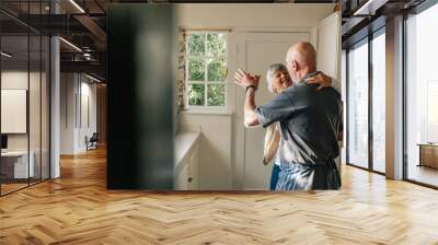 Senior couple dancing at home Wall mural