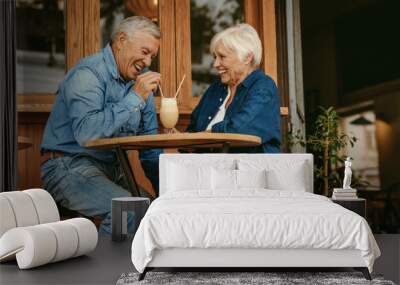 Senior couple having great time at cafe Wall mural