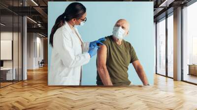 Senior man getting covid immunity vaccine Wall mural