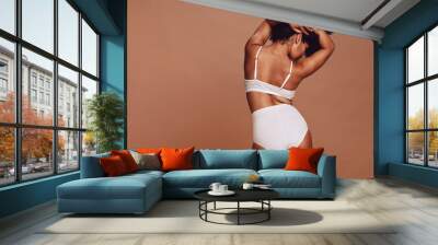 Sensual woman with curvy figure posing in lingerie Wall mural