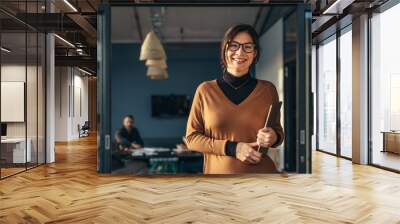 Smiling business woman in casuals at office Wall mural