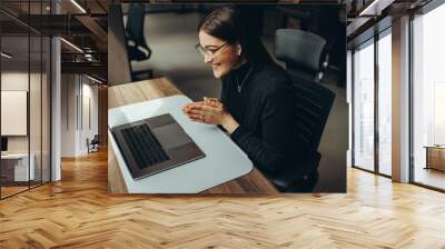 Smiling businesswoman attending a virtual meeting in an office Wall mural