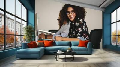 Smiling businesswoman working in office Wall mural