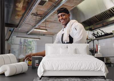 Smiling chef cooking food at restaurant kitchen Wall mural