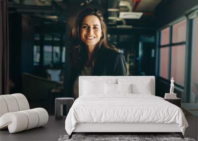 Smiling female executive in her office Wall mural