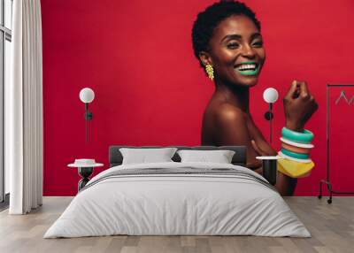 Smiling female model with artistic makeup Wall mural