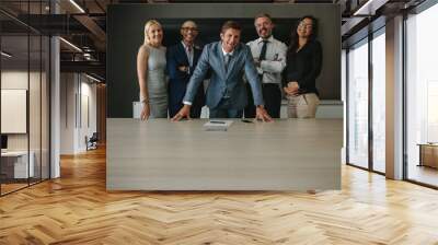 Smiling group of business professionals in meeting room Wall mural