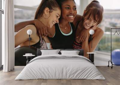 Smiling multi-ethnic female in gym after workout Wall mural