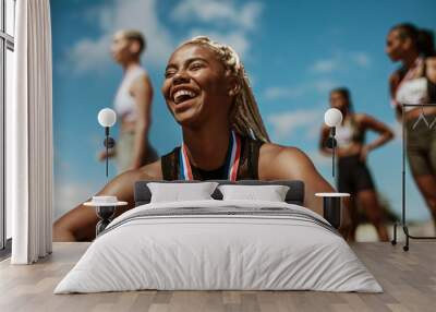 Sportswoman with medal celebrating her victory Wall mural