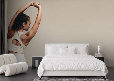 Sporty young female working out to improve her strength, flexibility and balance Wall mural